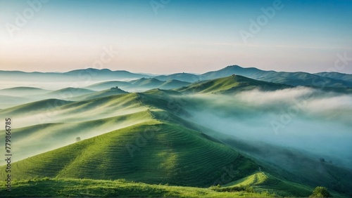 Green Hills Covered in Fog Against Blue Sky, Capturing the Beauty of Nature and Environmental Harmony