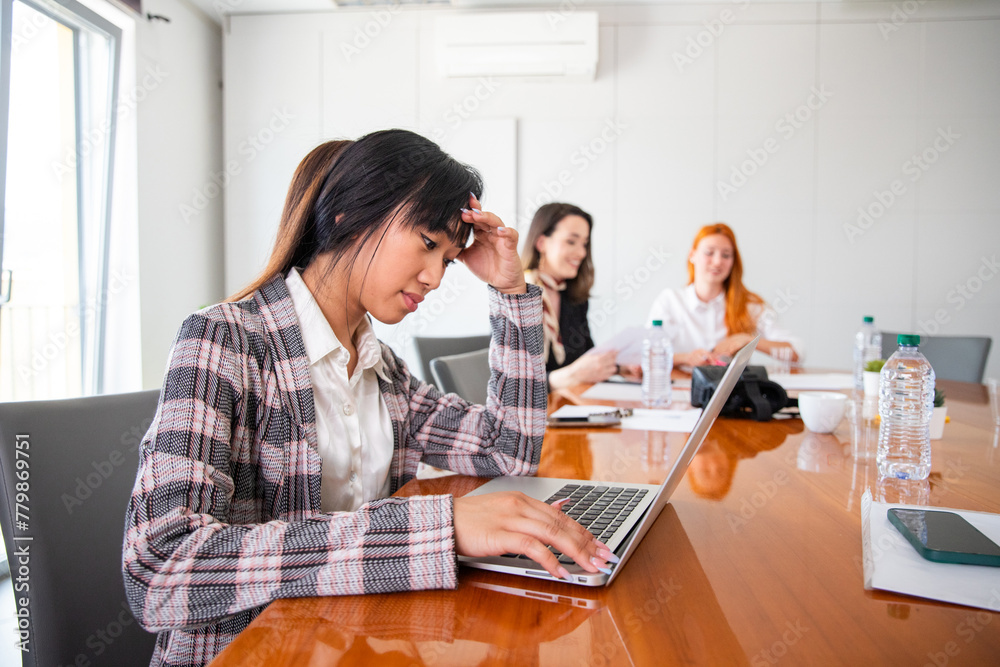 A businesswoman is stressed during work, she touches her forehead in despair A businesswoman is stressed during work, she touches her forehead in despair