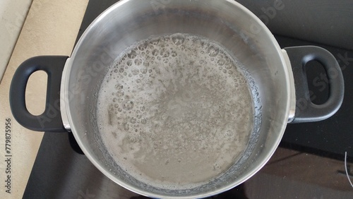 Fotografie Boiling sugar in a pan on the stove