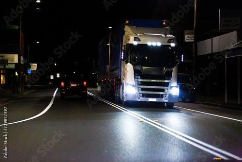 truck driving on highway late at night transporting goods  photo