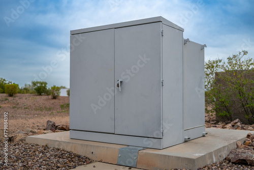 Selective focus on an electric transformer outside a commercial building. 