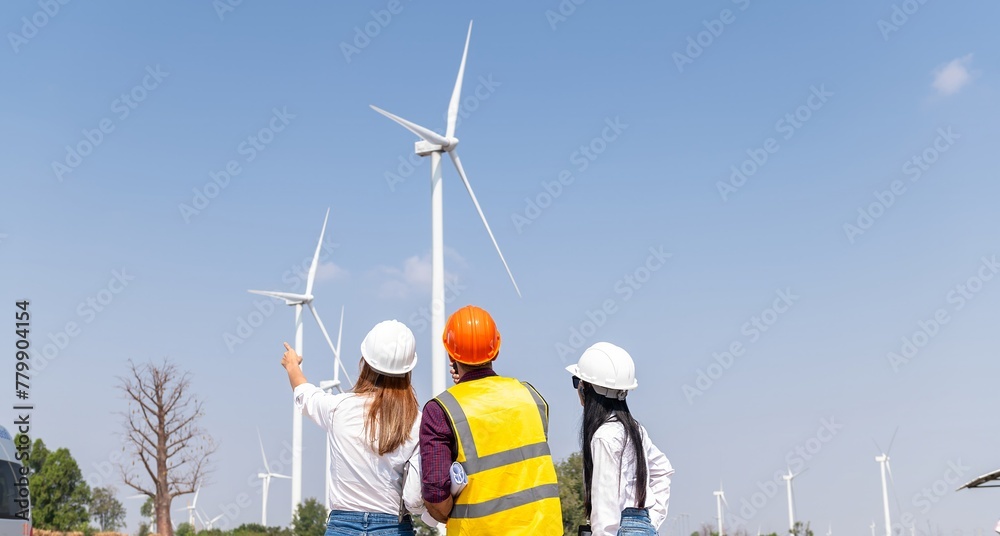 engineer team inspection check control wind power machine construction installation in wind energy factory. technician professional worker discussion check for maintenance electronic wind turbine