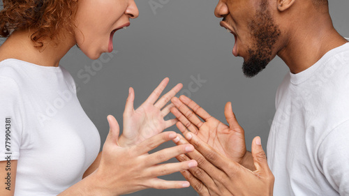 Young couple yelling at each other in studio