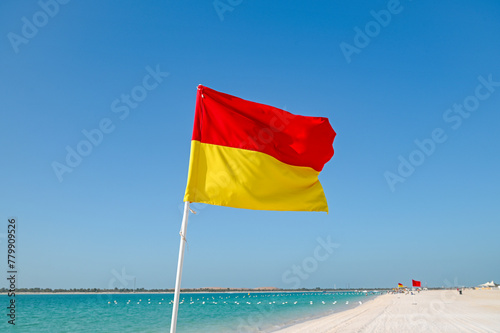 Red and Yellow lifeguard beach flag © Savvapanf Photo ©