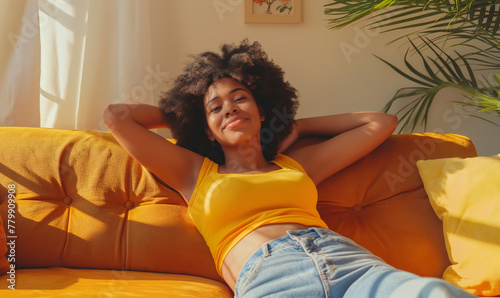 Joyful Afro American Woman Enjoying Relaxation on a Cozy Sofa at Home