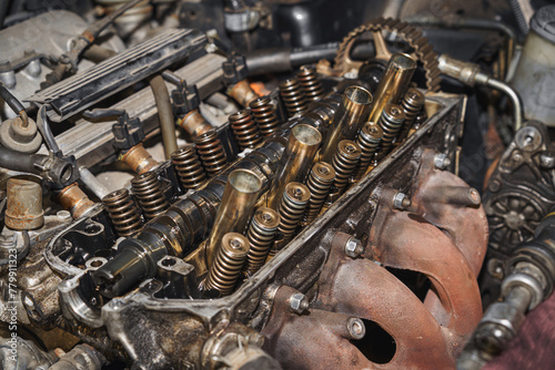 Close up of a car engine. Cylinder heads. Valves. Valve springs. Sixteen valves. Engine block. Exhaust manifold. Auto service. Car repairing.