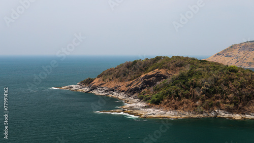 Image of a landscape in Phuket, Thailand near Promthep Cape, a beautiful seaside rock formation and blue waters.