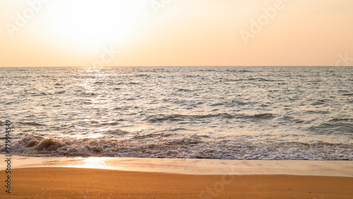 The sunset on the beautiful beach in the evening along with the orange sunlight gives the impression of a warm landscape.