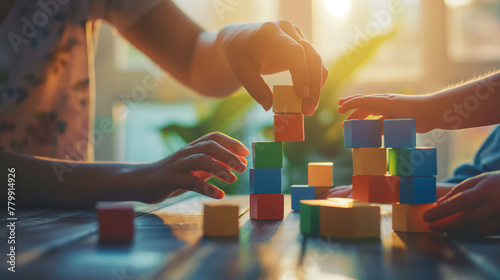 A psychologist and a child build a structure with blocks, a metaphor for problem-solving and overcoming obstacles. The natural daylight emphasizes the collaborative effort and the photo