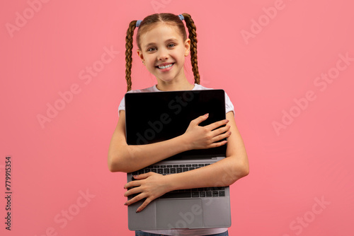 Konstfotografi Girl hugs laptop with a happy face on pink