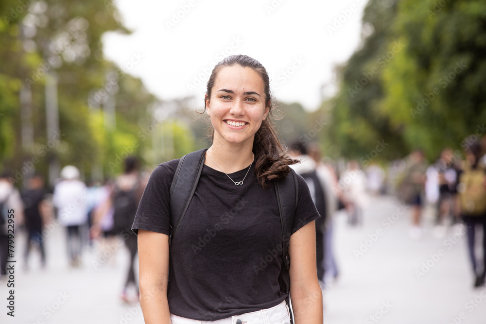Female aboriginal university student walking through college campus with her backpack Female aboriginal university student walking through college campus with her backpack