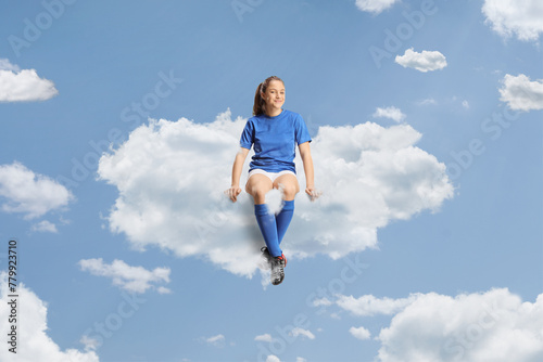 Teenage girl in a football jersey floating on a cloud © Ljupco Smokovski