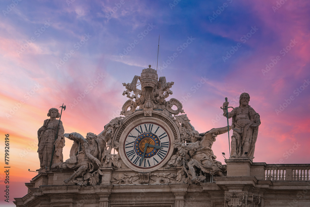 Stunning view of ornate clock and sculptures against twilight sky at the Vatican. Features Roman numerals, religious statues, and crest with symbolic elements. Sunset or sunrise colors. Stunning view of ornate clock and sculptures against twilight sky at the Vatican. Features Roman numerals, religious statues, and crest with symbolic elements. Sunset or sunrise colors.