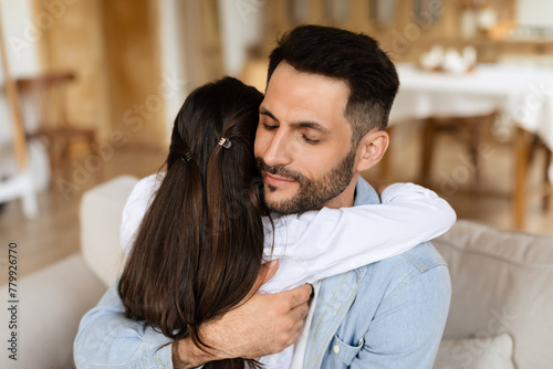 Daughter hugs father in a close embrace