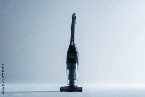 Modern cordless handheld vacuum cleaner standing upright on a clean surface
