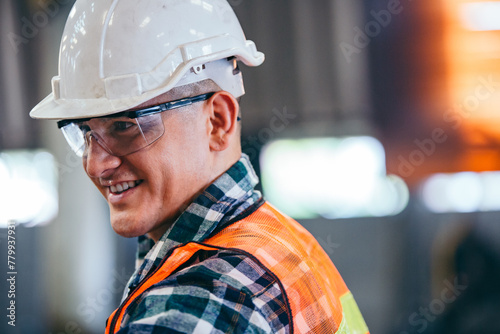 Portrait of indutry engineer foreman smiling. Man standing in the manufacturing factory. copy space photo
