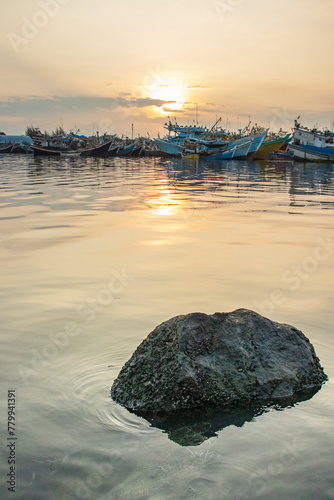 Sunrise at the fishing harbor with fishing boats parked