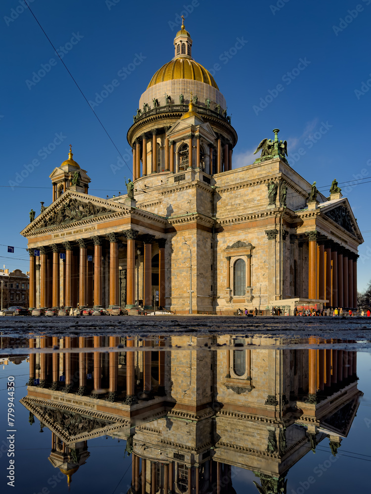 incredible reflection in spring puddles of St. Isaac's Cathedral in St. Petersburg - Russia at sunny eather