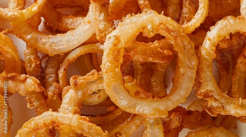 Crispy onion rings with dipping sauce close-up texture background 