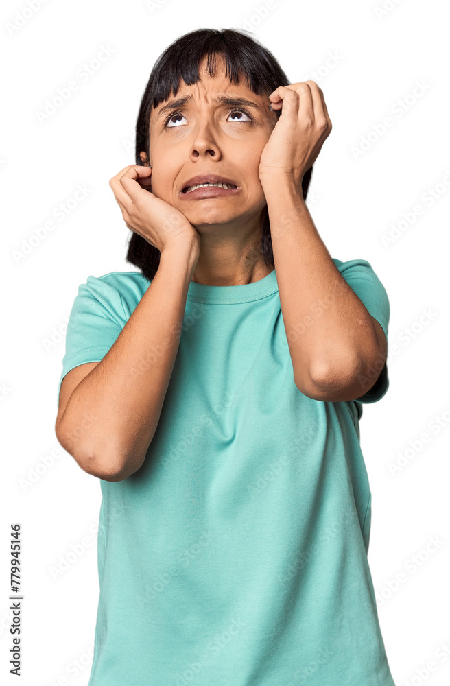 Young Hispanic woman with short black hair in studio whining and crying disconsolately. Young Hispanic woman with short black hair in studio whining and crying disconsolately.