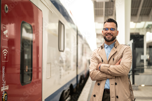 Young man on train station, portrait posing looking at a camera