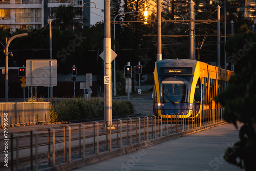 The G:link light rail tram on the Gold Coast passing through station with Surfers Paradise buildings photo
