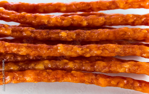 Many thin sausages on a white background