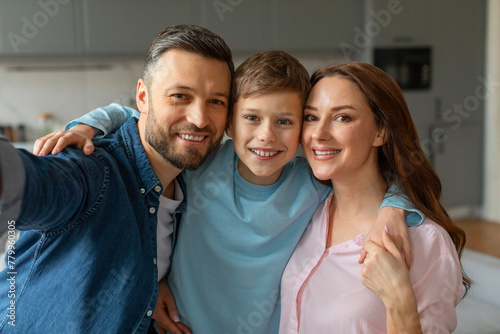 Happy family posing for a selfie at home © Prostock-studio