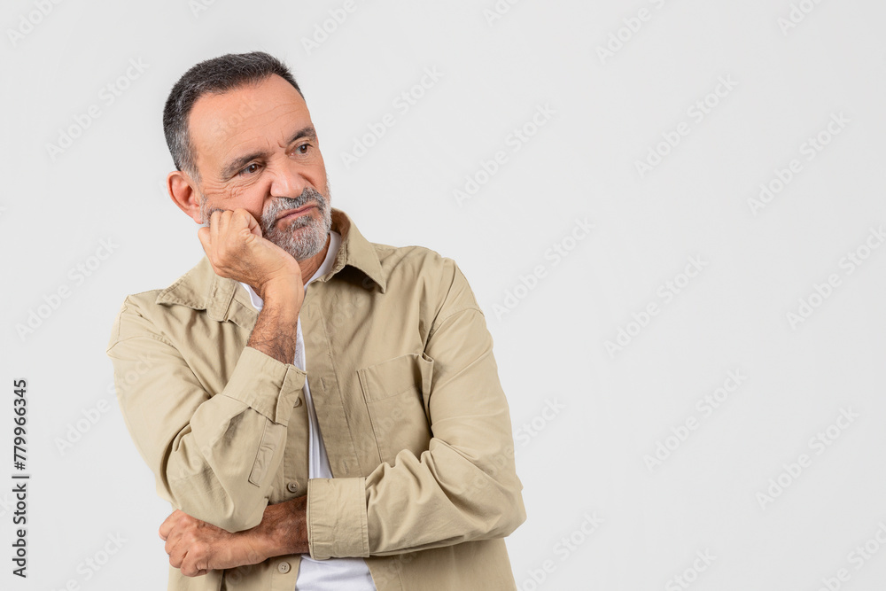 Pensive senior man with folded arms, copy space Pensive senior man with folded arms, copy space