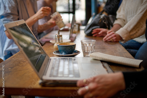 Canvas Print People working in a coffee shop with laptop computers