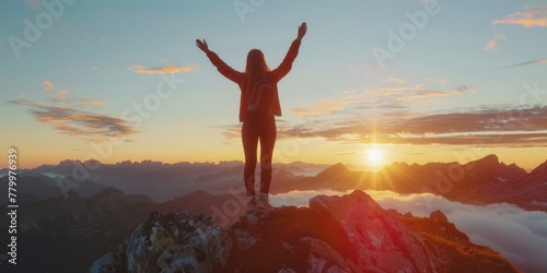 A woman is standing on a mountain top, looking up at the sun. She is wearing a red jacket and has a backpack on her back. The scene is peaceful and serene, with the sun shining brightly in the sky