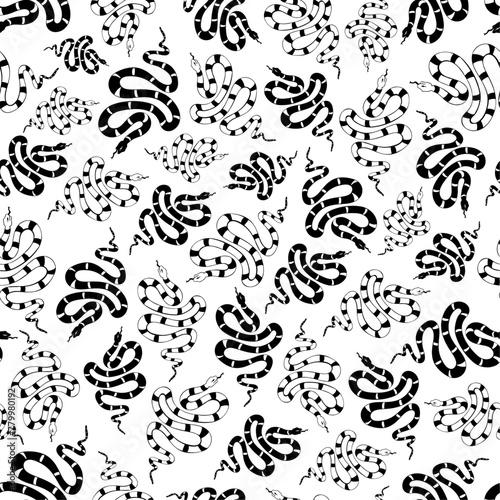 Black and white drawing of snakes arranged in vector seamless pattern. A group of freehand drawn snakes that vary in size are swarming and rotating across a white backdrop.
