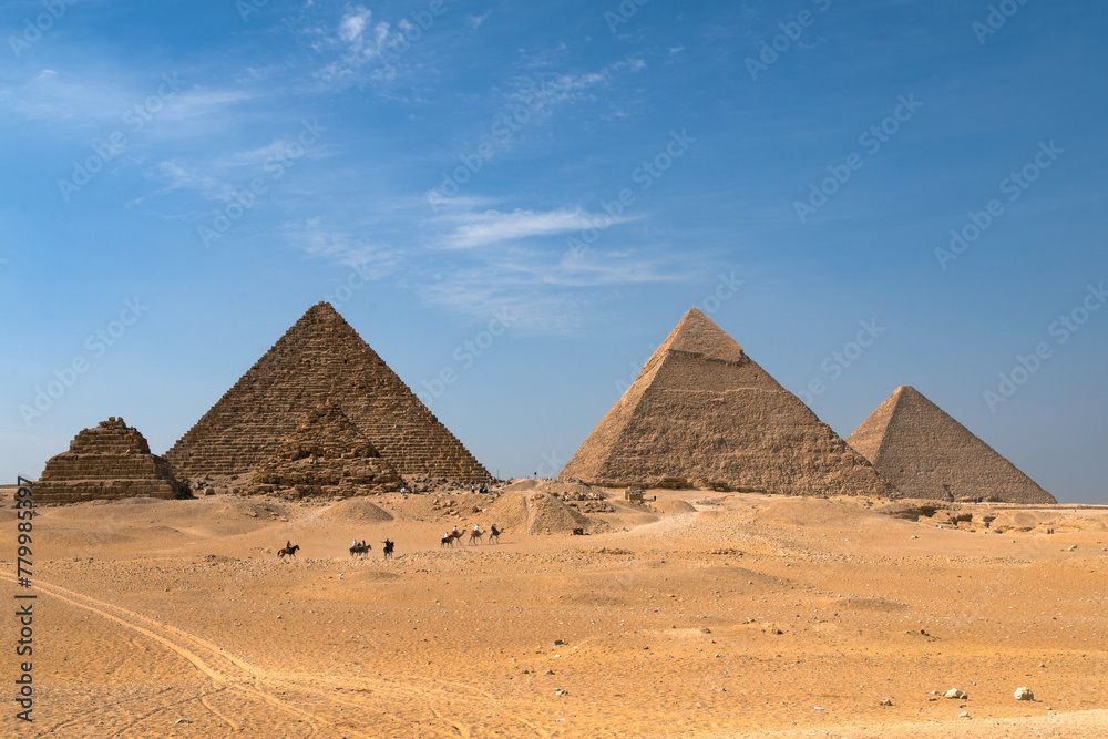 View of the Egyptian pyramids with a caravan in the foreground View of the Egyptian pyramids with a caravan in the foreground