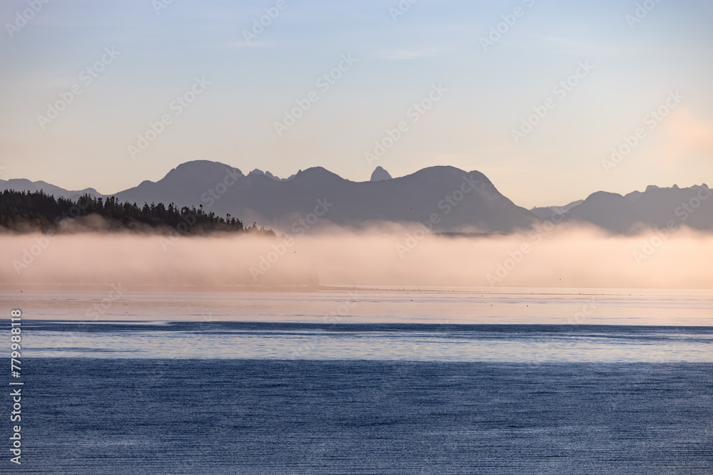 Misty lake framed by mountains, creating a serene natural landscape Misty lake framed by mountains, creating a serene natural landscape