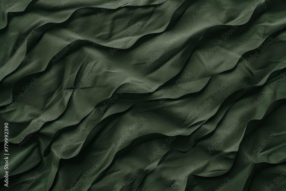   A detailed view of a green fabric, featuring undulating lines at its upper and lower edges