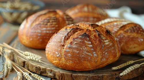  A collection of loaves on a wooden table, one beside a bowl of oatmeal
