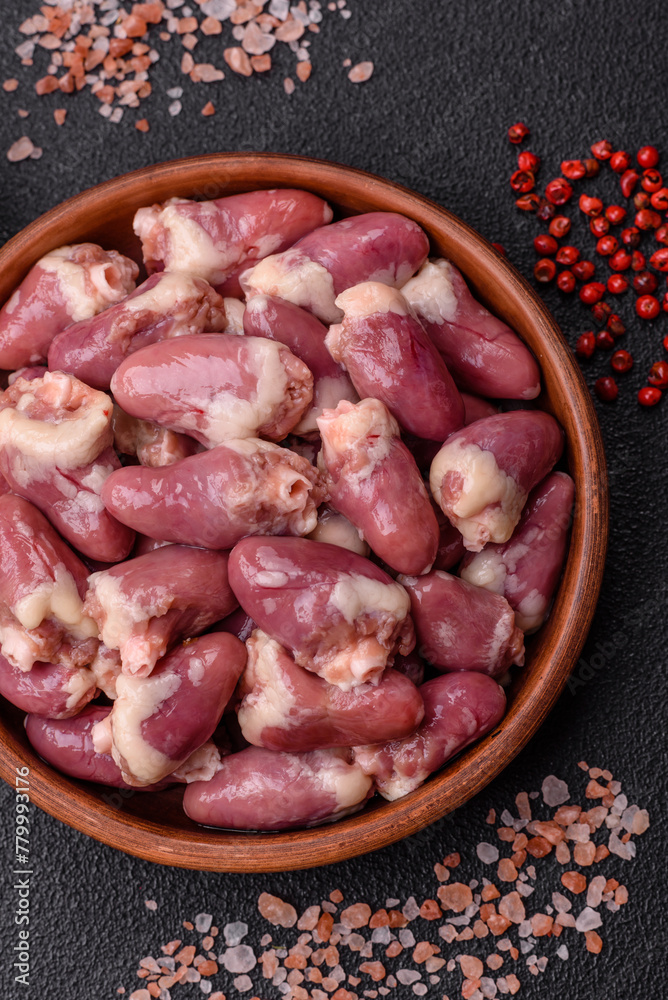 Raw chicken hearts with salt, spices and herbs Raw chicken hearts with salt, spices and herbs
