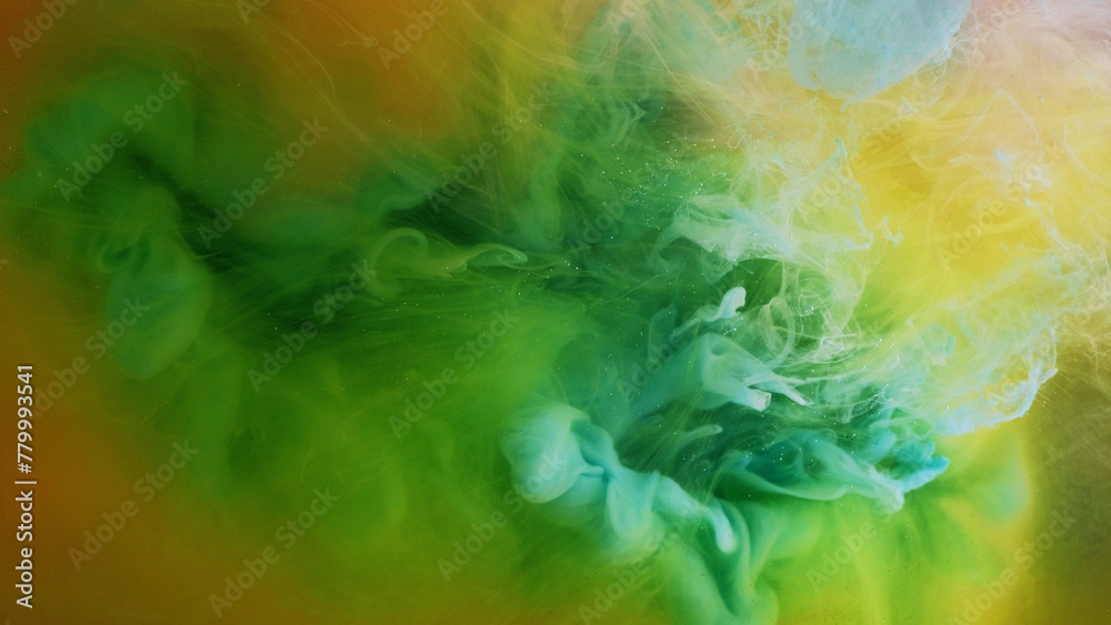 Color splash. Ink water explosion. Fantasy smoke. Bright green yellow blue orange fluid haze paint wave mix flow abstract art background.