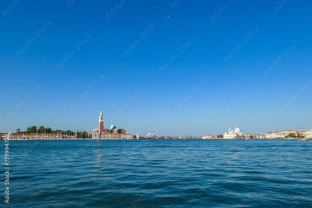 Scenic view of church on the Island of San Giorgio Maggiore, Venice, Veneto, Northern Italy, Europe. Perspective from San Mark Square. Soft light in tranquil atmosphere. Boat trip in Venetian lagoon