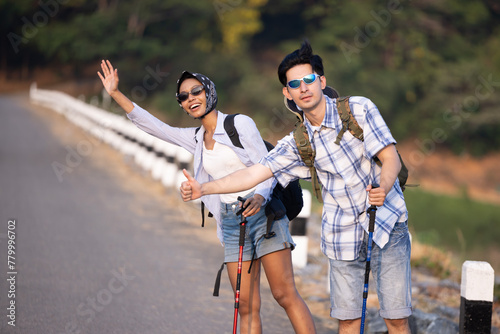Travellers hitchhiking for the ride  during trip