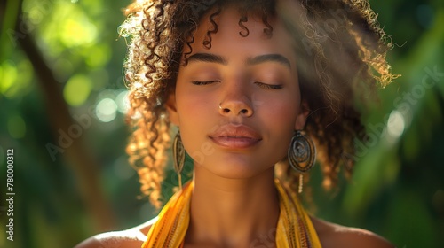 A dark-skinned girl with curly hair, surrounded by greenery, with her eyes closed.