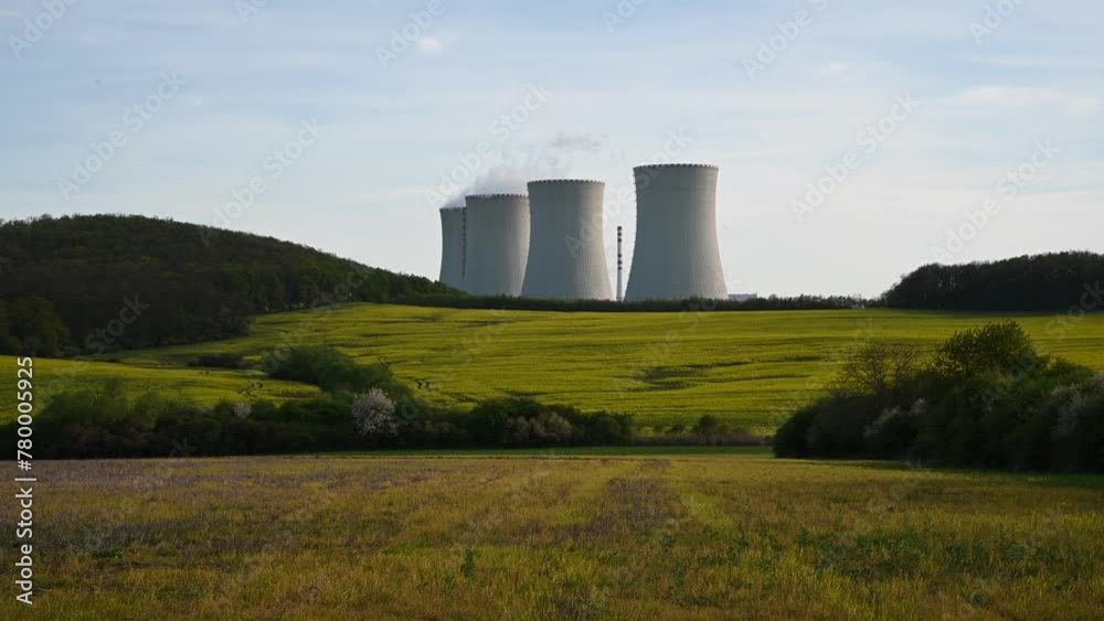 Cooling towers of nuclear power plant with the yellow field of rapeseed, canola or colza. Mochovce. Slovakia. Cooling towers of nuclear power plant with the yellow field of rapeseed, canola or colza. Mochovce. Slovakia.