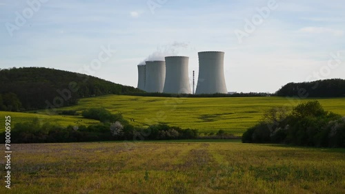 Cooling towers of nuclear power plant with the yellow field of rapeseed, canola or colza. Mochovce. Slovakia. photo