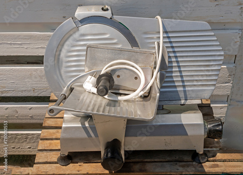 Electric meat slicer machine outdoors on a market stall © Tatty