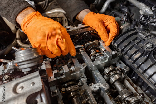 Mechanic's Hands Repairing Car Engine in Auto Service