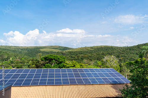 Hotel Rio De Pedras. Photovoltaic solar tiles installed on farms. Forest. Blue sky with clouds.