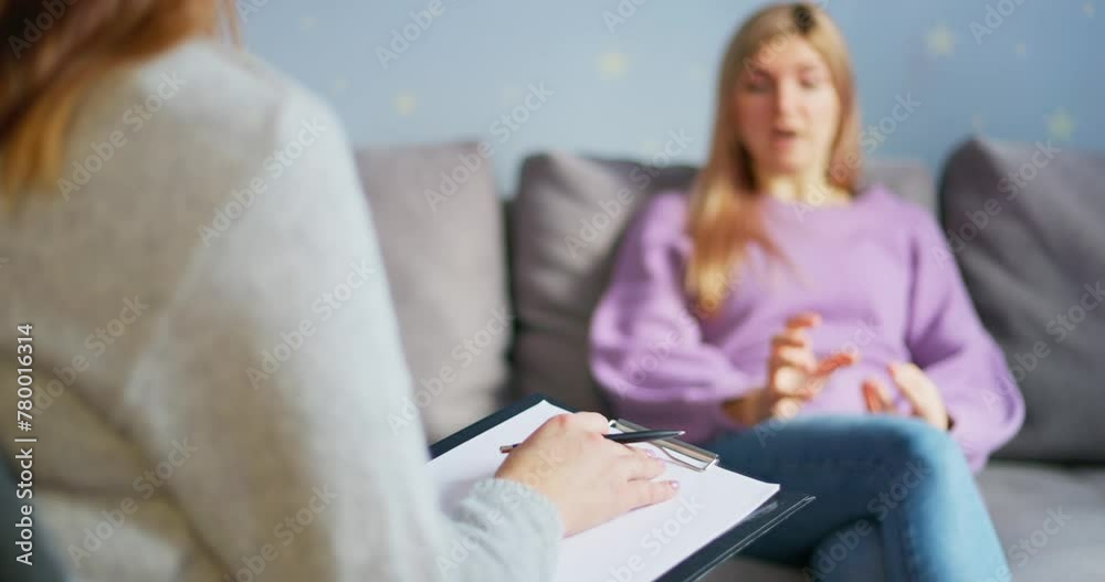 Woman in counseling session with blurred therapist in foreground