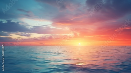 The image features a serene ocean sunset with calm waters reflecting the vibrant colors of the fiery sky © Damerfie