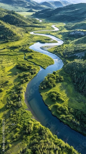 River Flowing Through Lush Green Valley © yganko