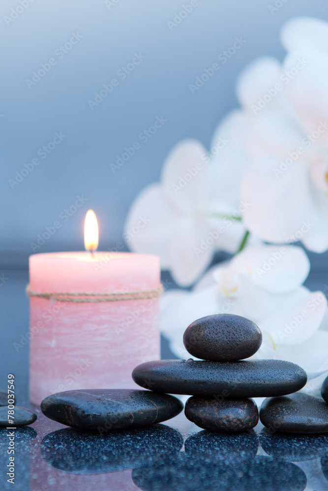 Obraz premium Spa background with white orchid , candle and zen black stones on gray.